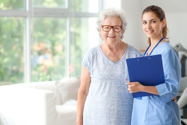 Elderly Woman with Caregiver in Nursing Elderly Woman with Caregiver in Nursing