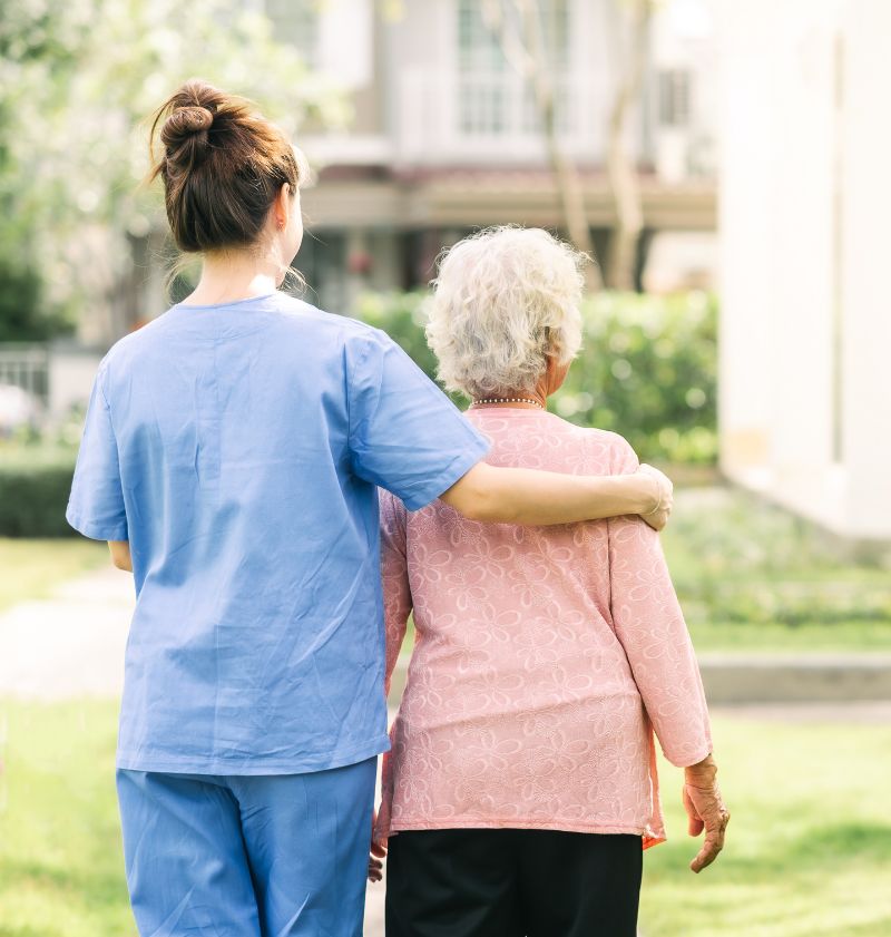 caregiver walking with elderly woman outdoor caregiver walking with elderly woman outdoor